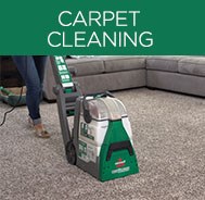 Woman using BISSELL® Big Green® Carpet Cleaning Machine Rental to deep clean carpet